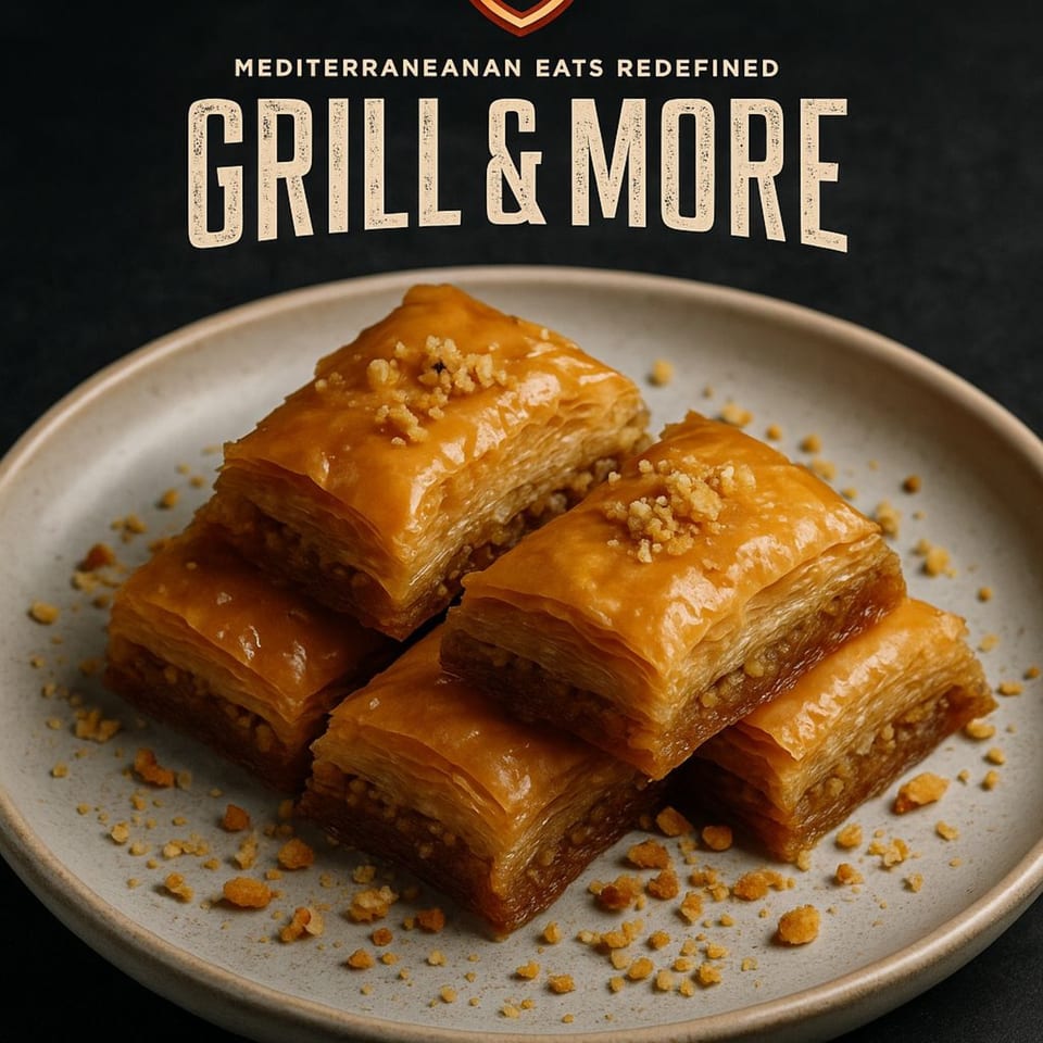 Four pieces of golden baklava with chopped nuts on a light grey plate, with "Grill & More" text.