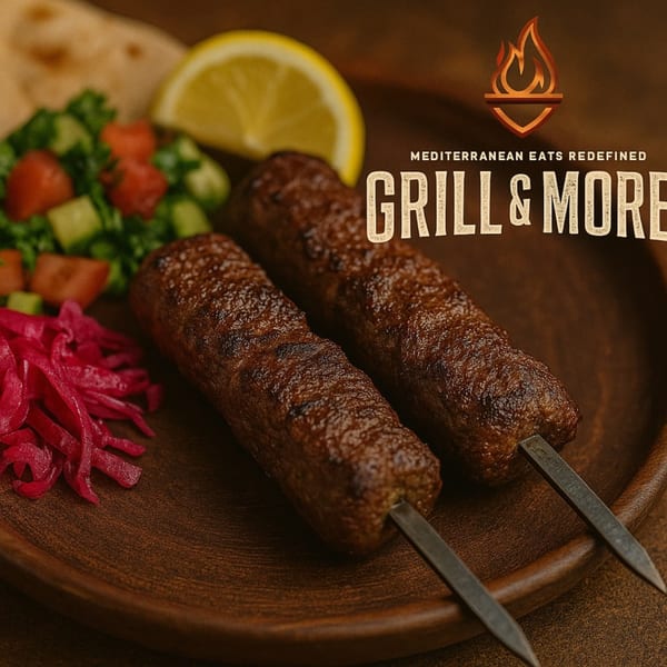 Two grilled Mediterranean kebabs with salad, pickled onions, and a lemon wedge on a wooden plate.