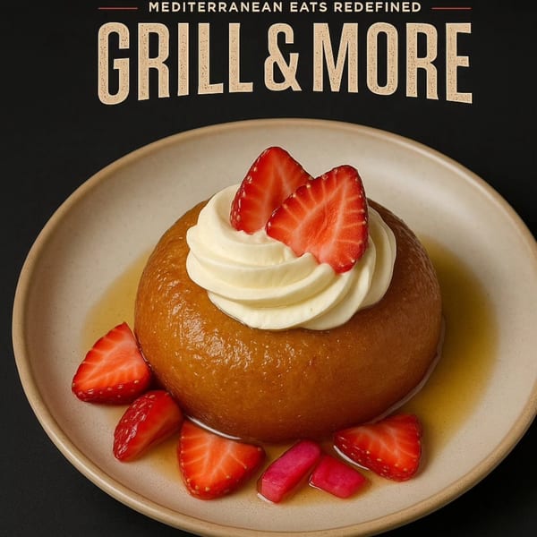 A golden-brown dessert with whipped cream and fresh strawberries on a light plate.