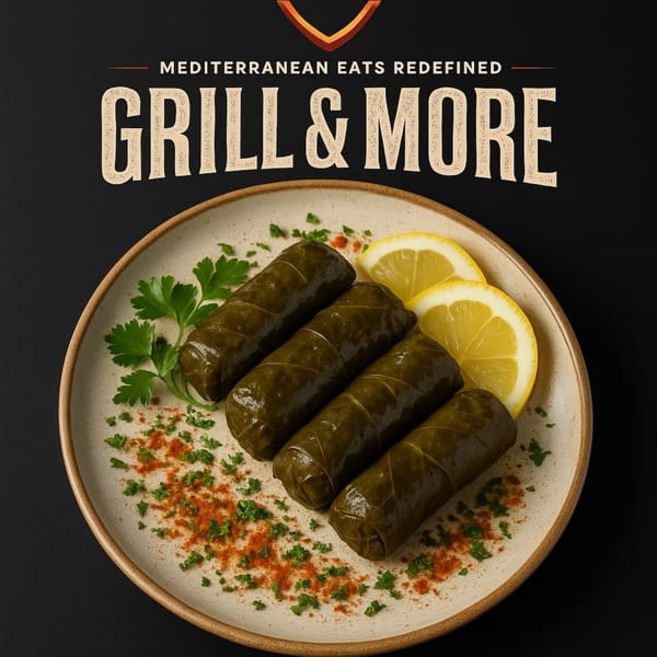 Four dolmades, garnished with parsley, paprika, and lemon slices on a white plate.